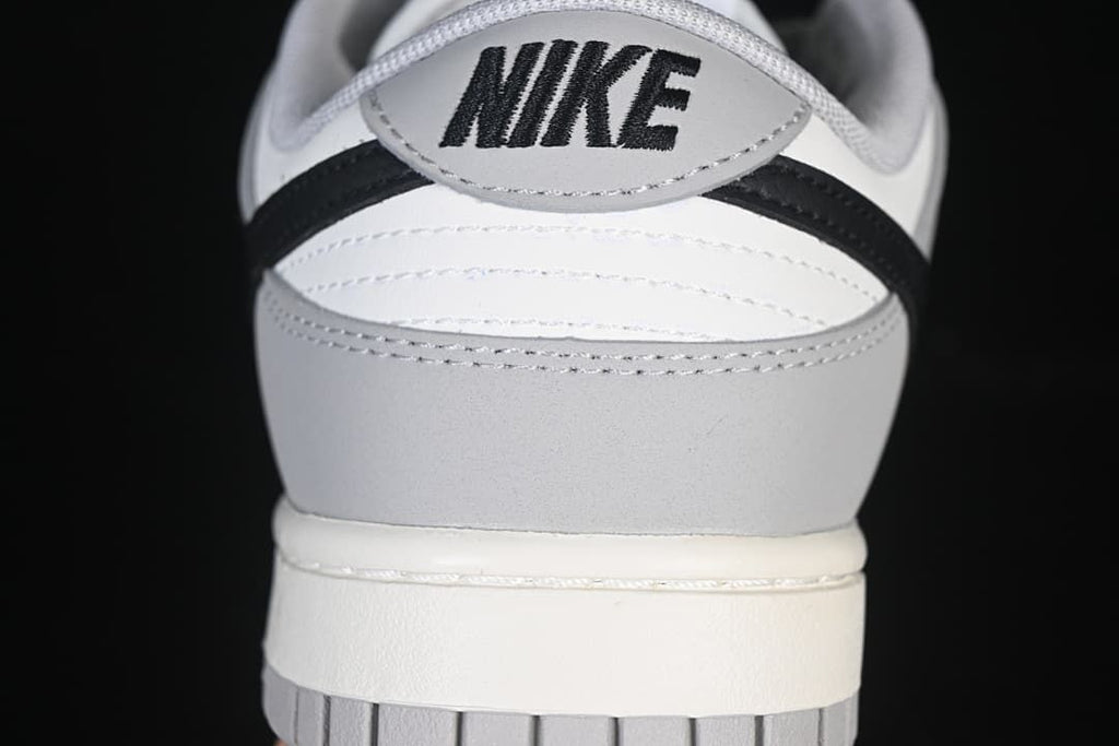 Rear view of the sneaker with grey, white, and black panels