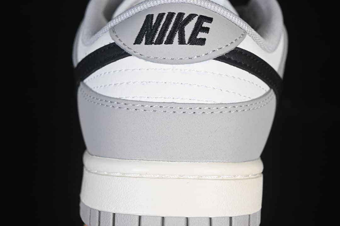 Rear view of the sneaker with grey, white, and black panels
