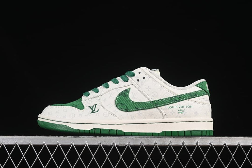 Side view of a white and green low-top SB Dunk sneaker with patterned panels and green accents