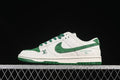 Side view of a white and green low-top SB Dunk sneaker with patterned panels and green accents