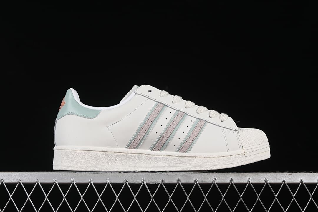 Side profile of the sneaker with pale aqua and pink stripes