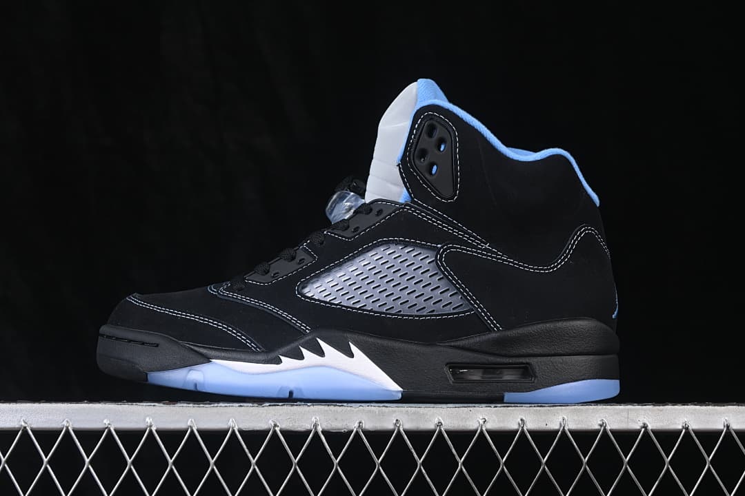 Opposite side view of a black high-top sneaker with blue and white accents.