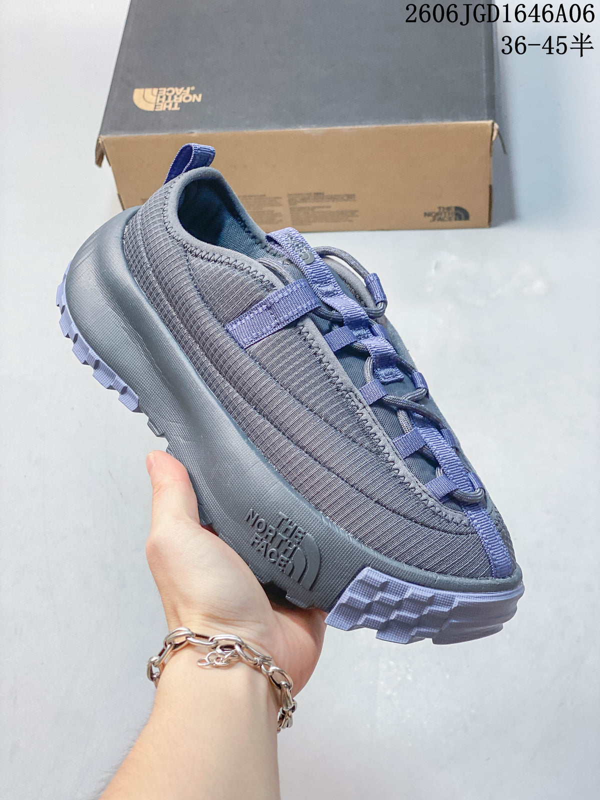 Angled side view of the gray mule shoe with lavender accents