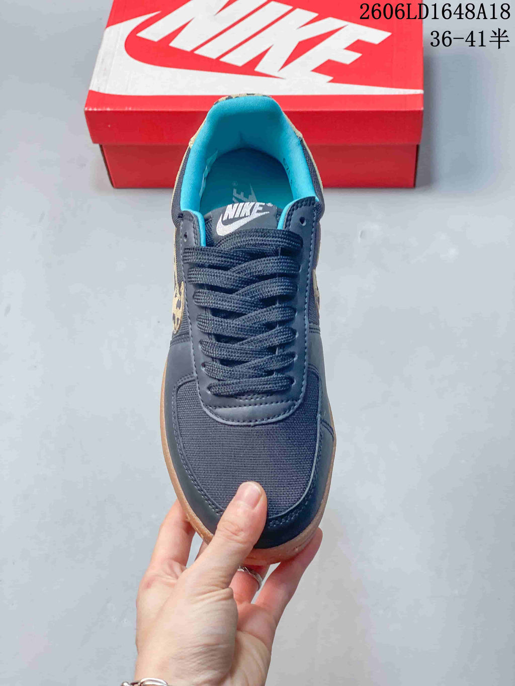 Top view showing the laces, dark navy upper, and turquoise lining