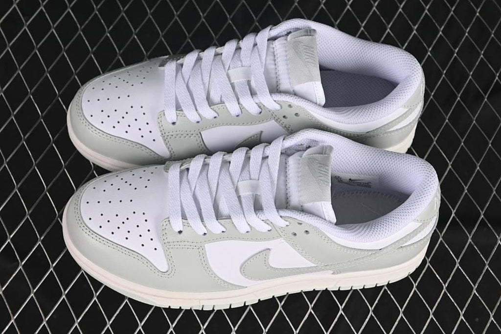 Pair of white and grey low-top sneakers shown from above