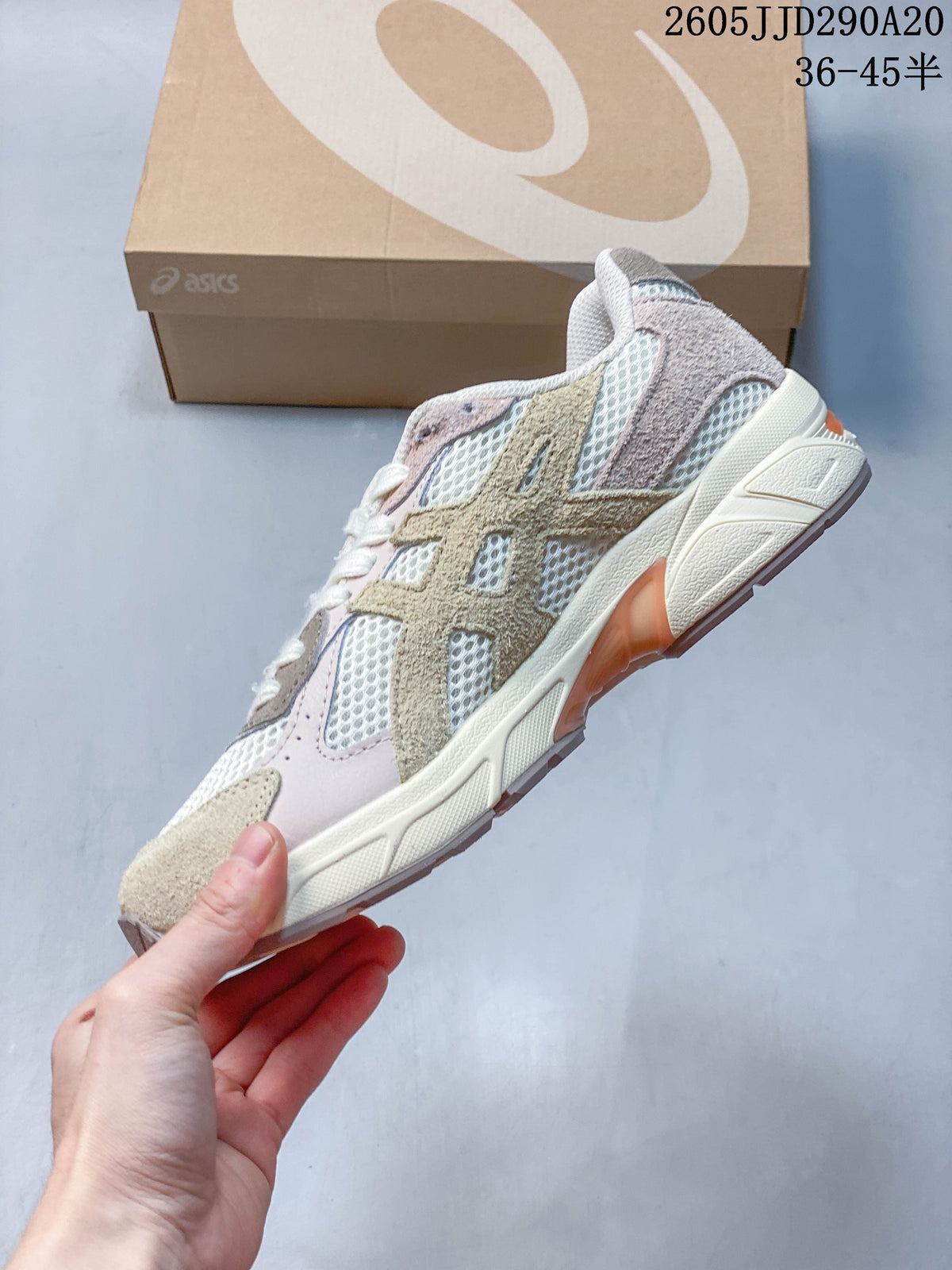 Side profile of the cream and taupe ASICS GEL-1130 sneaker with mesh panels and layered overlays.