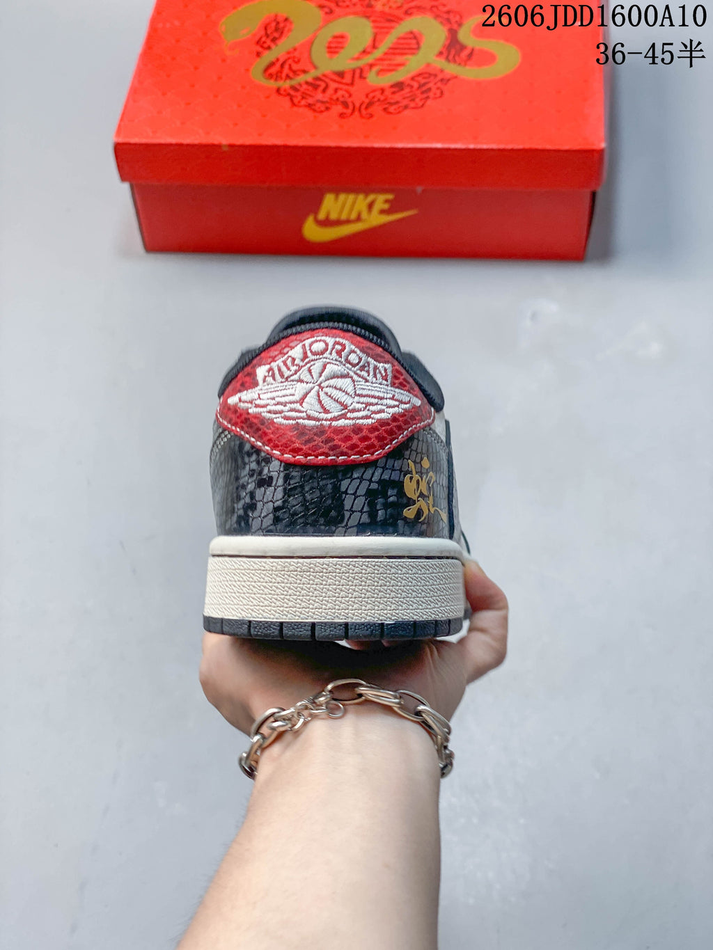 Rear view showing patterned heel panels and a red embroidered heel tab