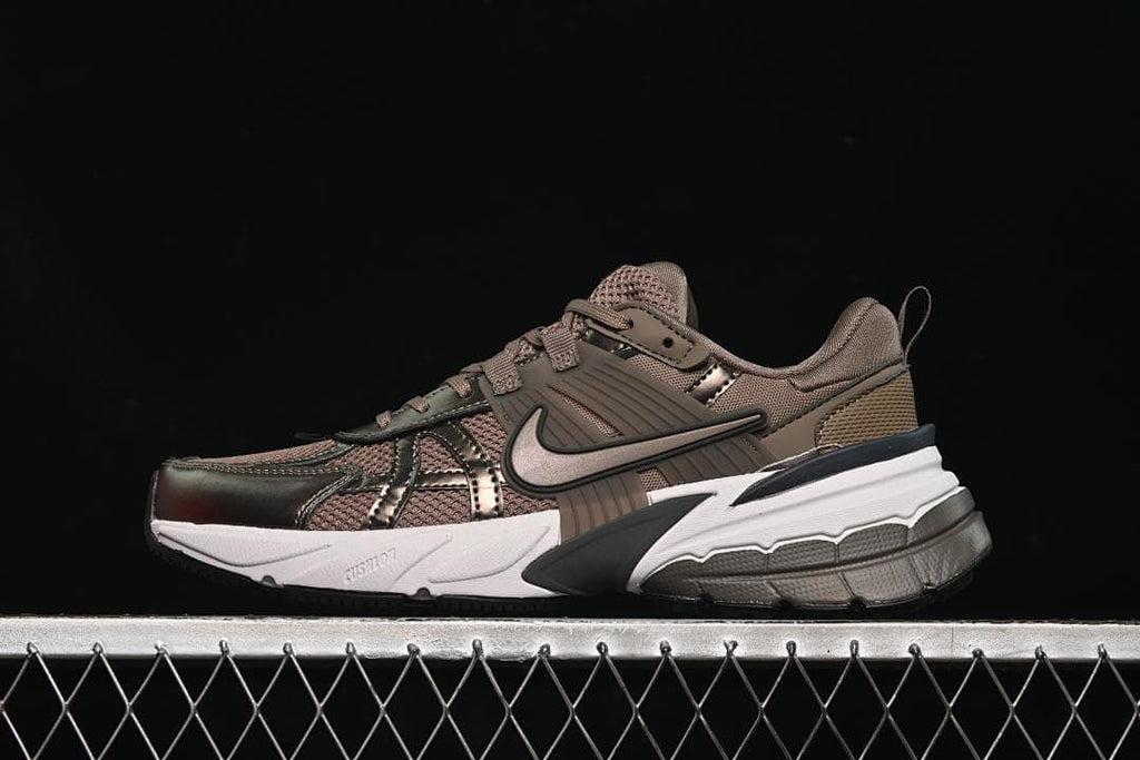 Side view of brown Nike V2K Run sneakers with a white sculpted midsole