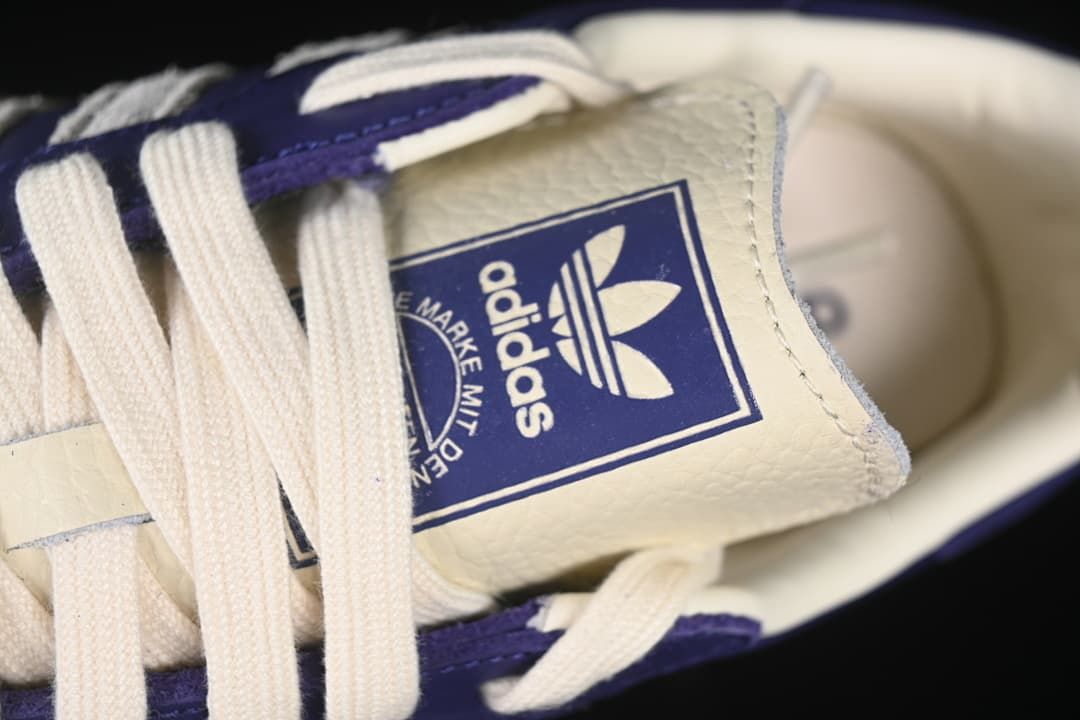 Close-up of the adidas tongue label and cream-colored laces