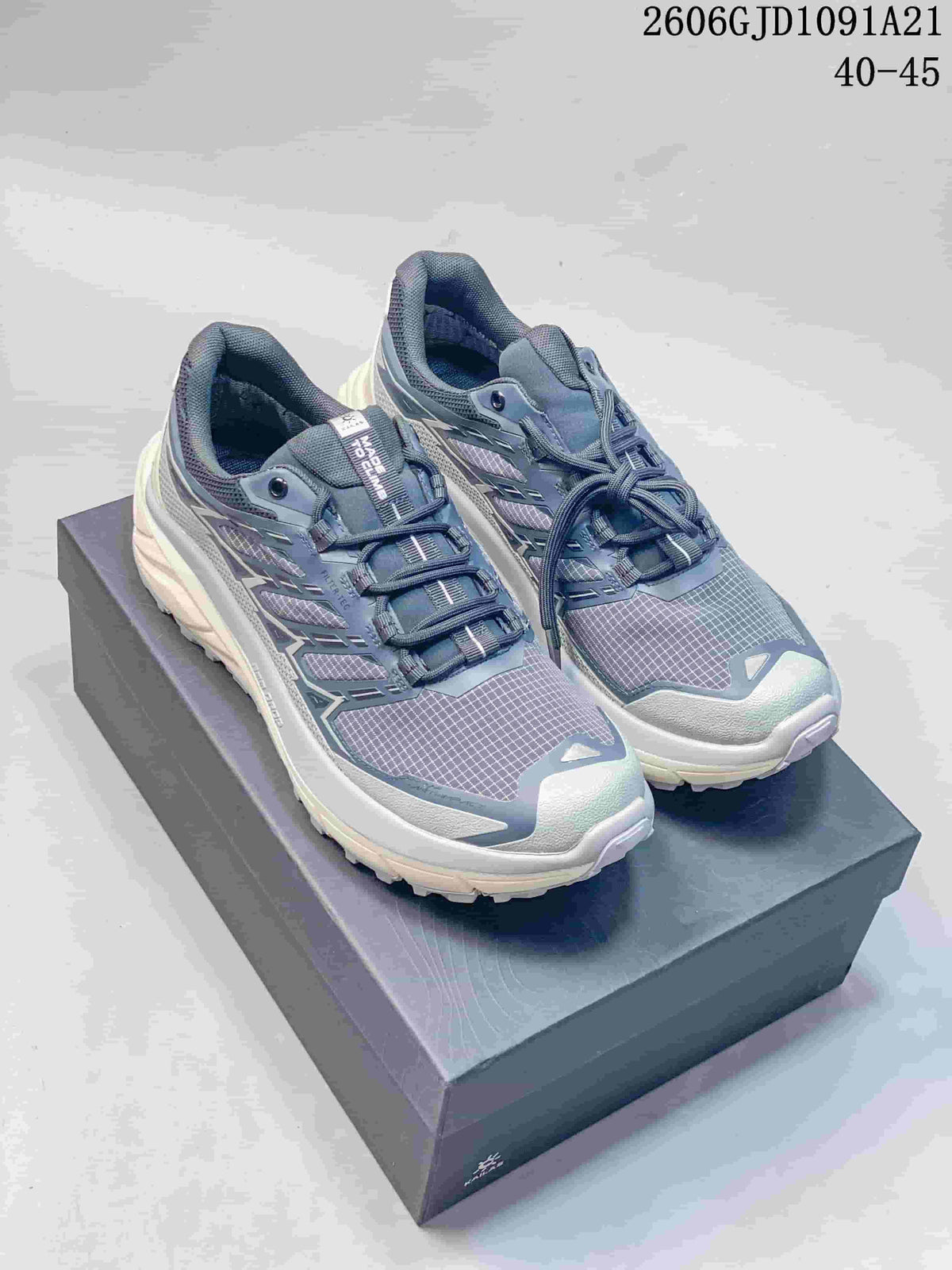 Pair of dark blue-gray KAILAS trail-running shoes displayed on a box.