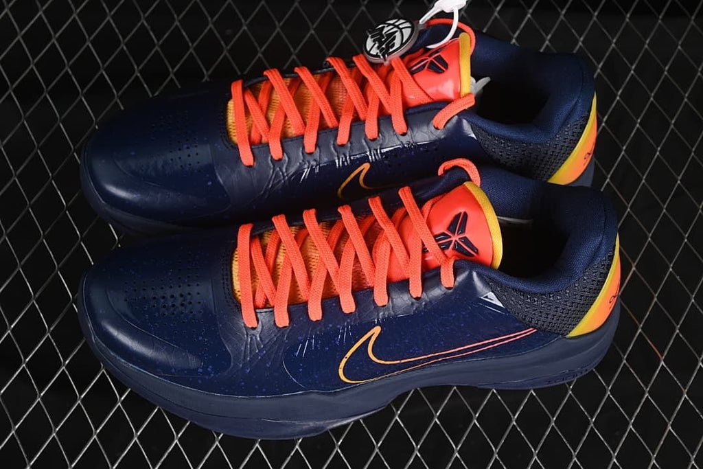 Pair of navy shoes with coral laces, shown from above.