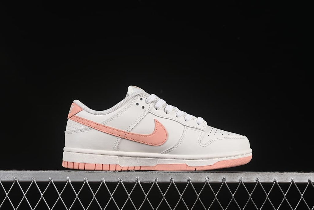 Side profile of the off-white sneaker with pink accents