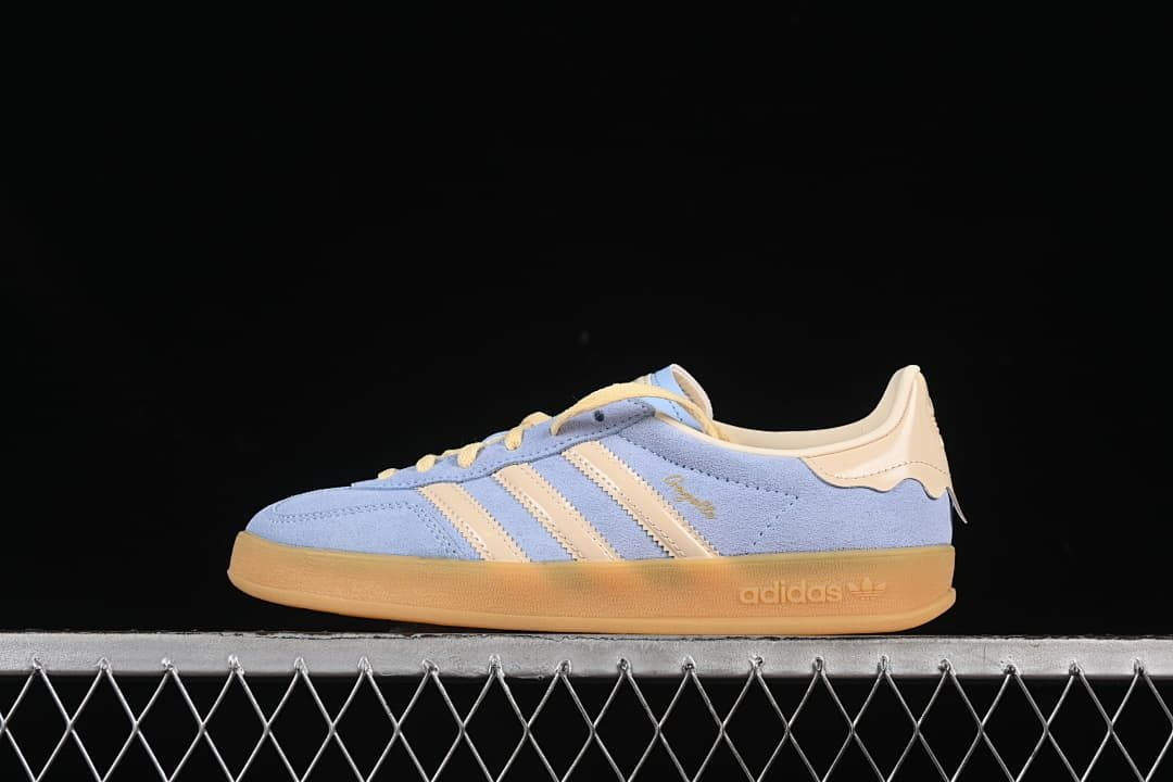 Side view of the light blue adidas Originals Gazelle Indoor with cream stripes and a gum-colored sole