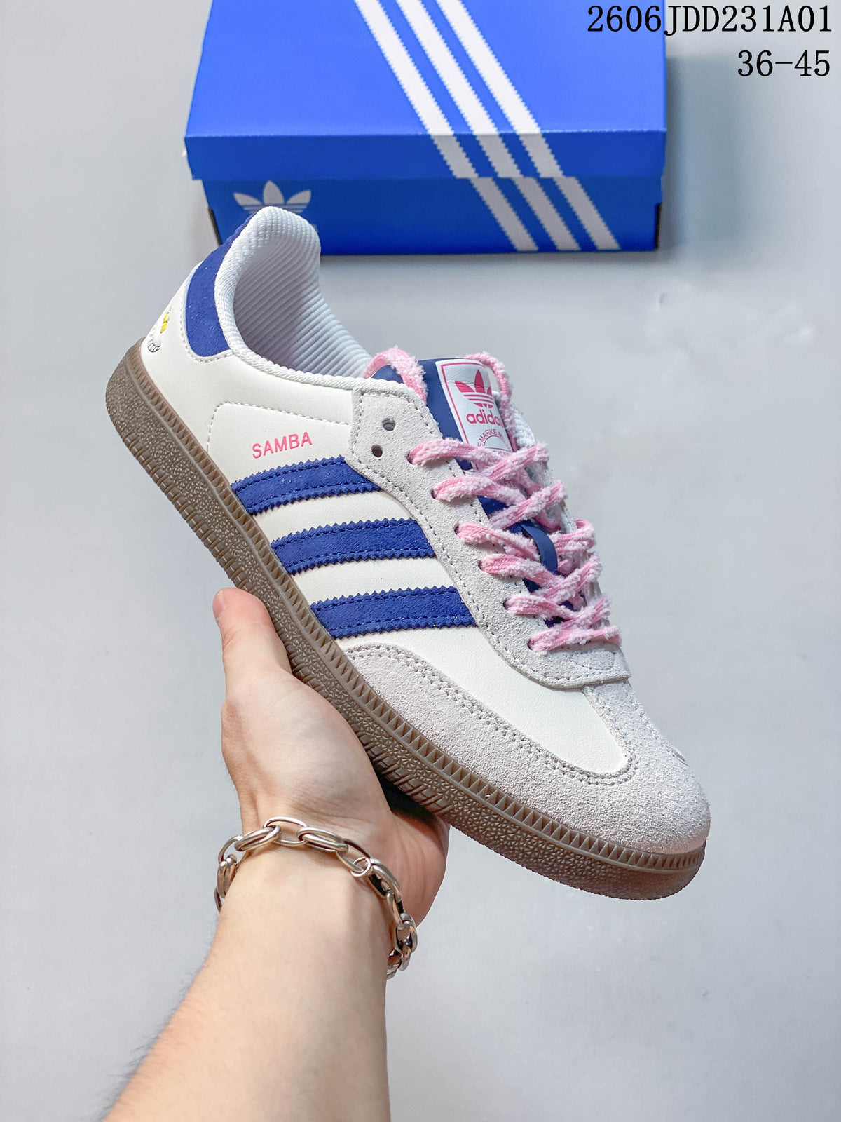 Angled side view of the Samba OG sneaker with pink laces and blue stripes