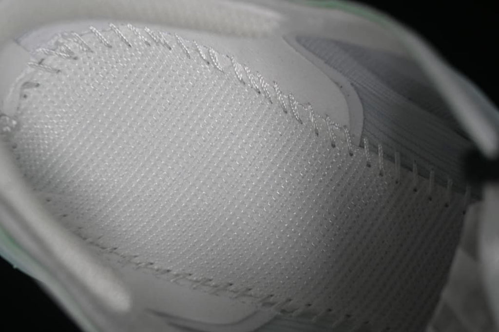 Close-up of the textured white shoe upper and lacing