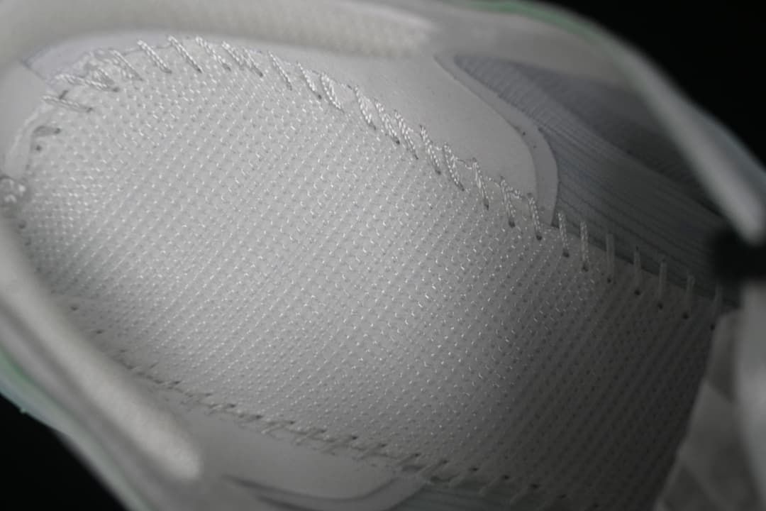 Close-up of the textured white shoe upper and lacing