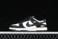 Side view of black and white low-top sneakers with contrasting stitching and graphic details