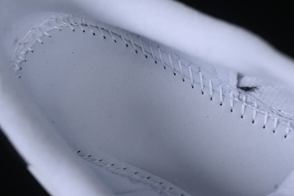 Close-up of stitching inside the white sneaker