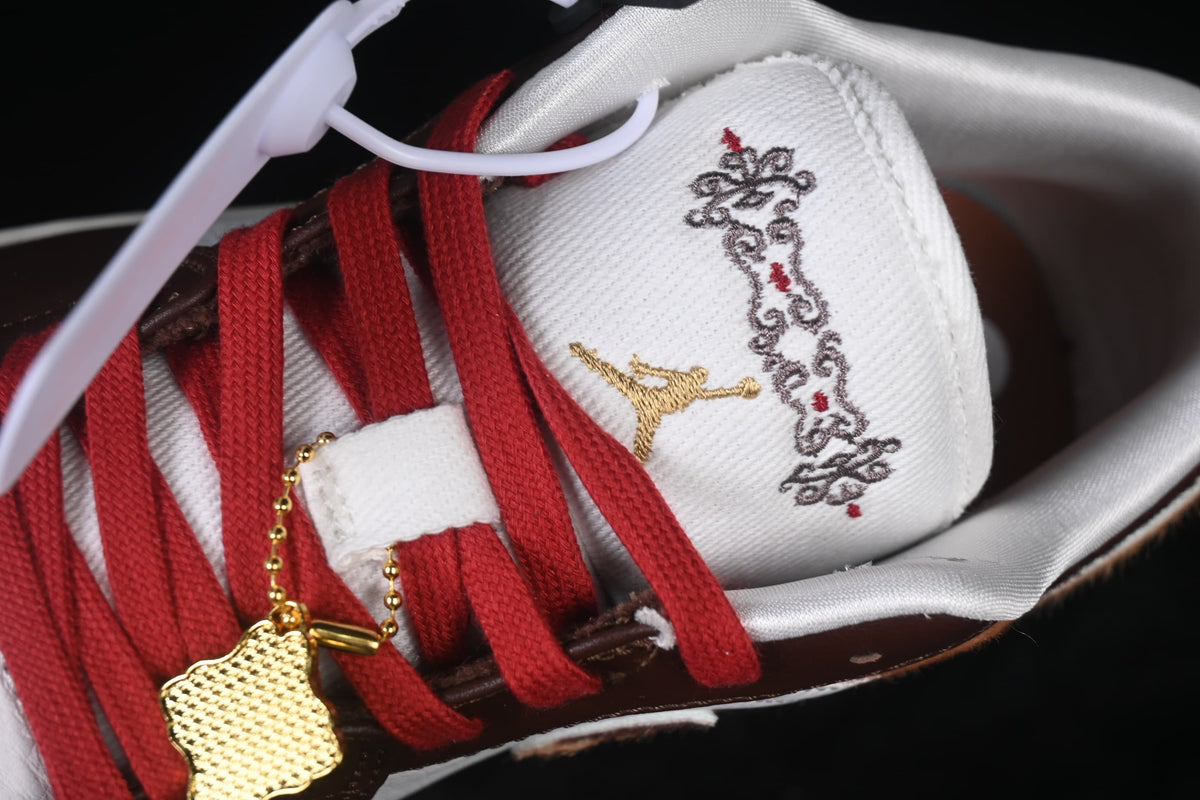 Close-up of the tongue embroidery and gold-tone lace charm.