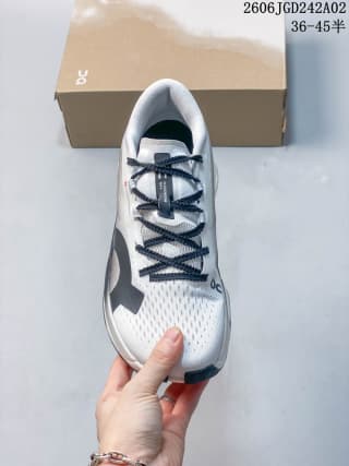 Top view of the ON Cloudboom Max shoe showing the perforated upper, dark laces, and tongue branding.