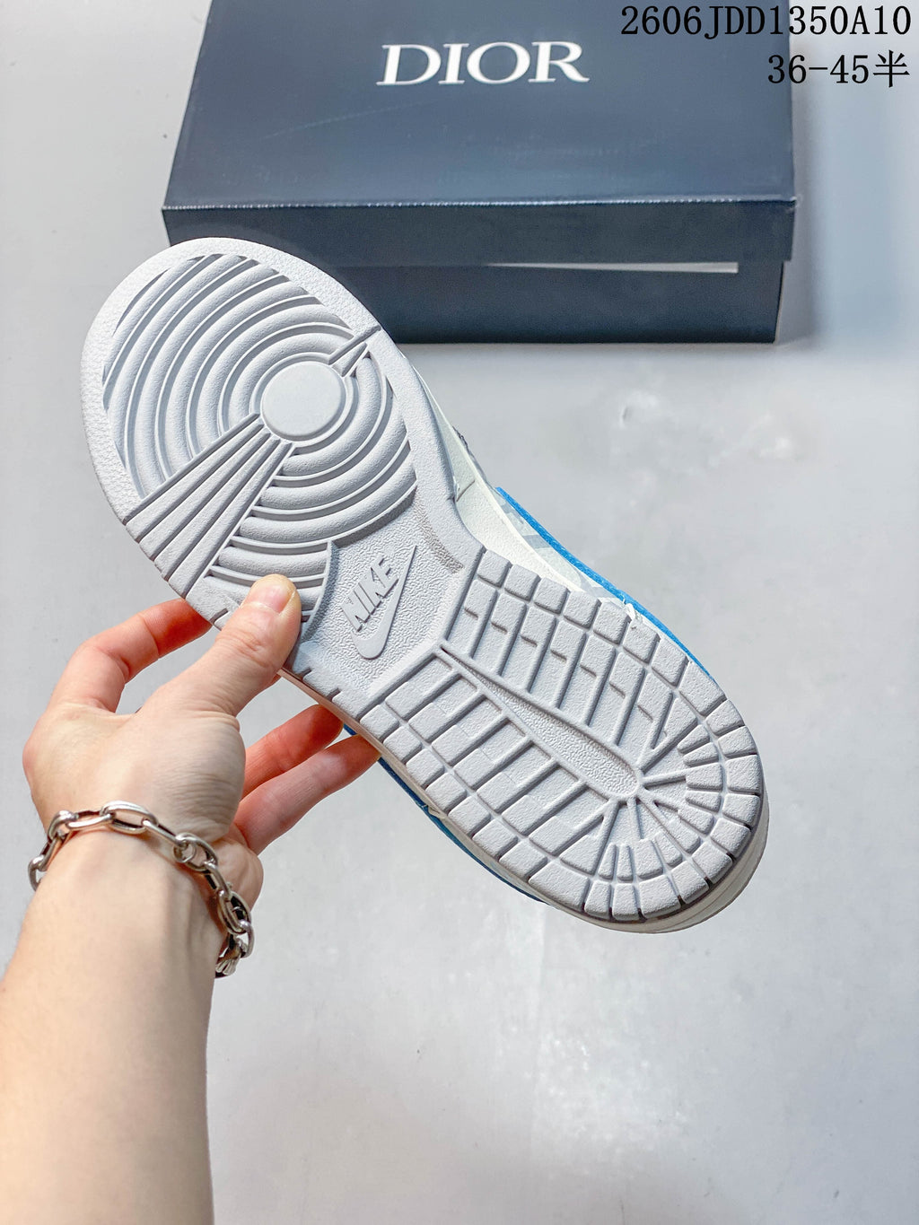 Underside of the sneaker showing a gray patterned rubber outsole and tread.