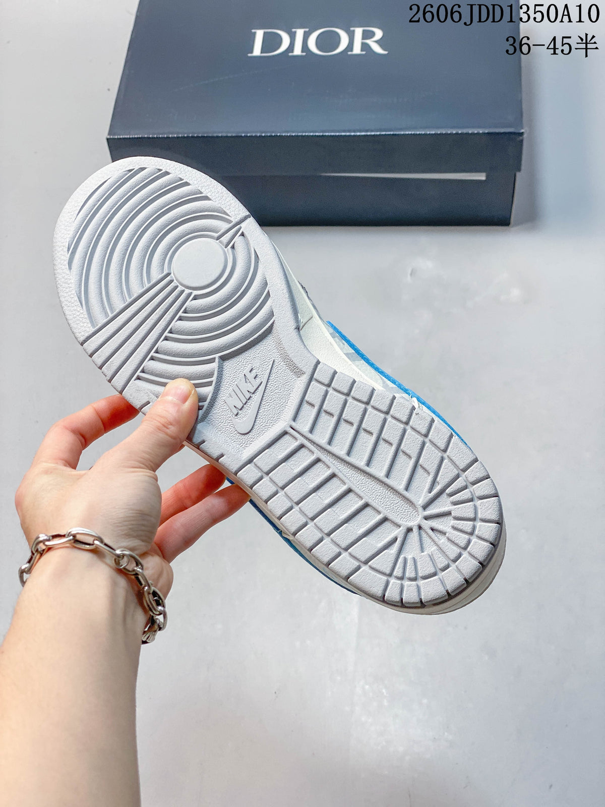 Underside of the sneaker showing a gray patterned rubber outsole and tread.