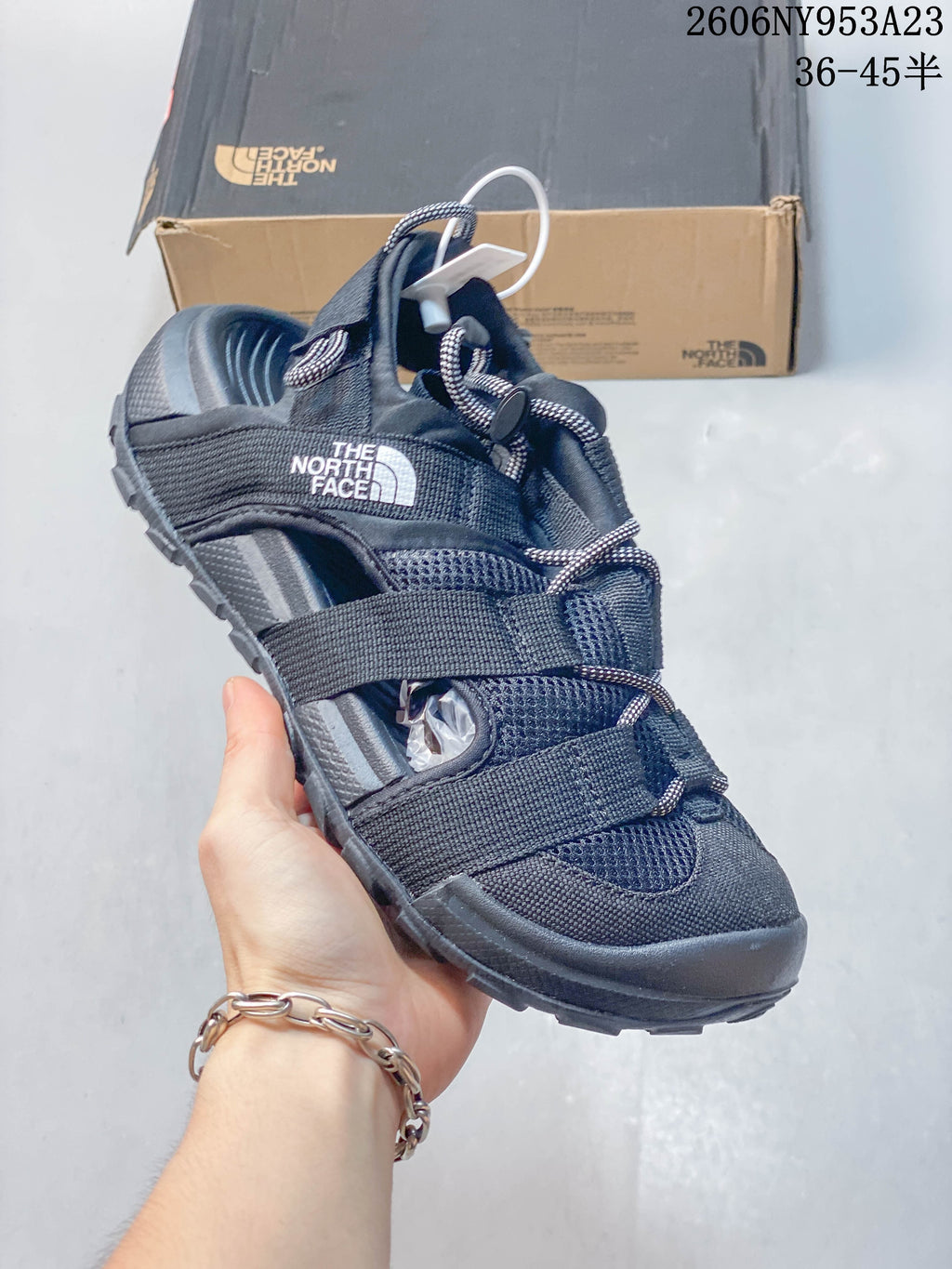 Angled view of the black sandal showing its adjustable straps and open-toe design.
