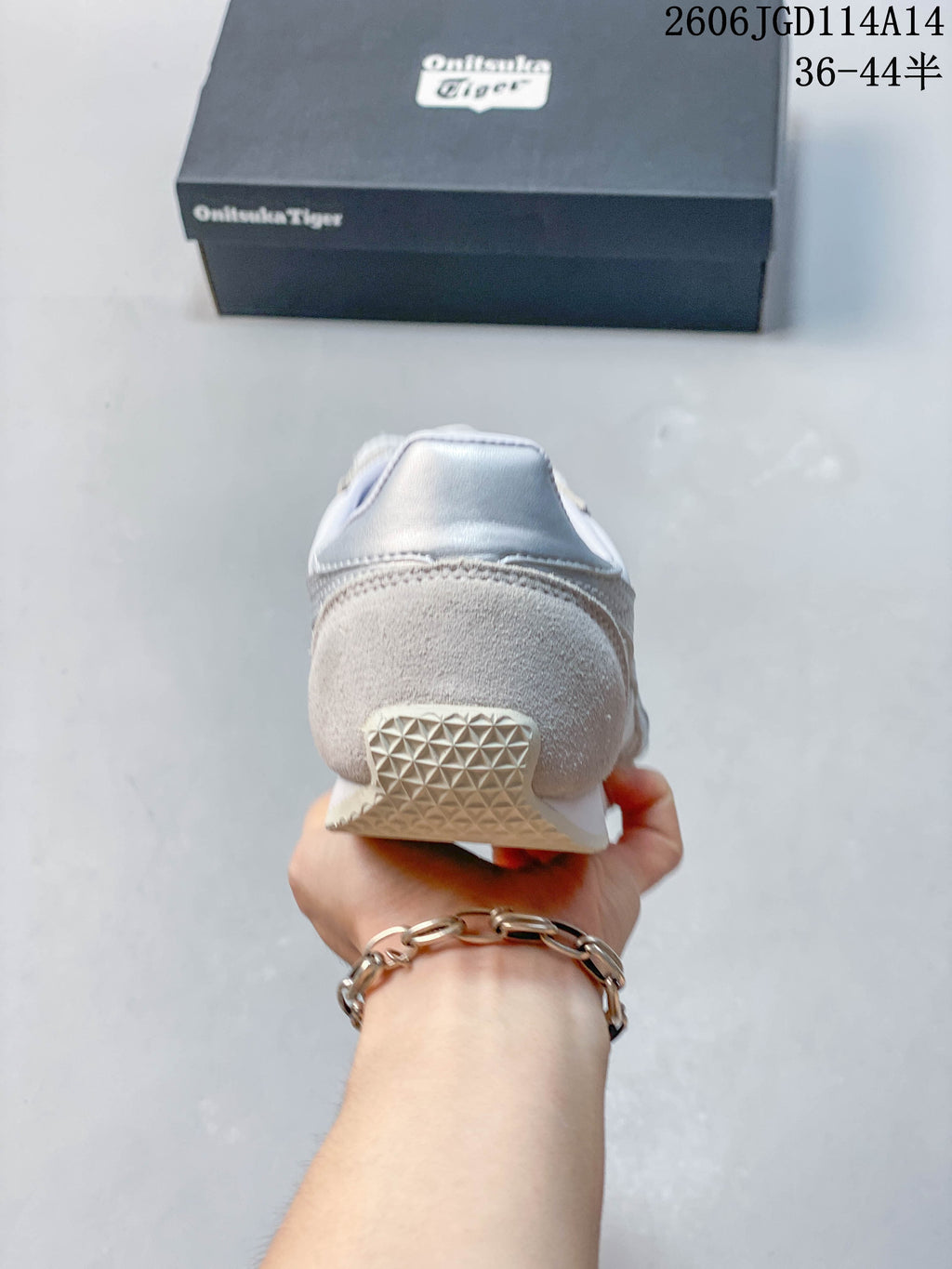 Rear view showing the light gray heel overlay and outsole of the sneaker
