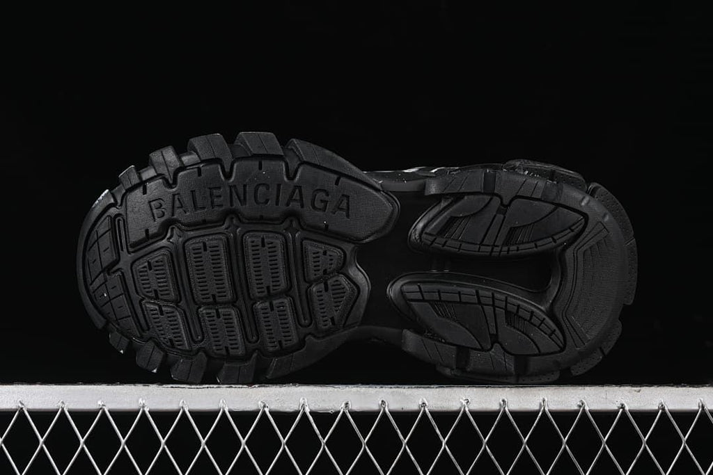 Underside view showing the sneaker's patterned black tread.