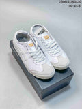 Pair of white Onitsuka Tiger Mexico 66 low-top sneakers with light gray accents on a shoebox