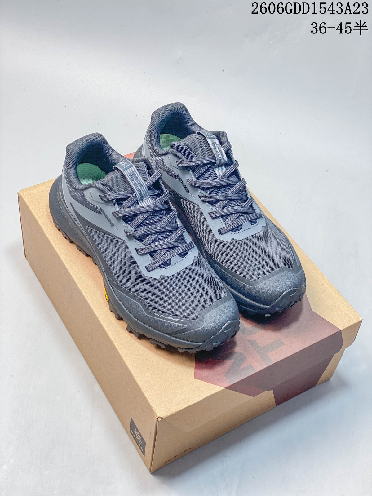 Pair of gray Kailas trail running shoes displayed on a box