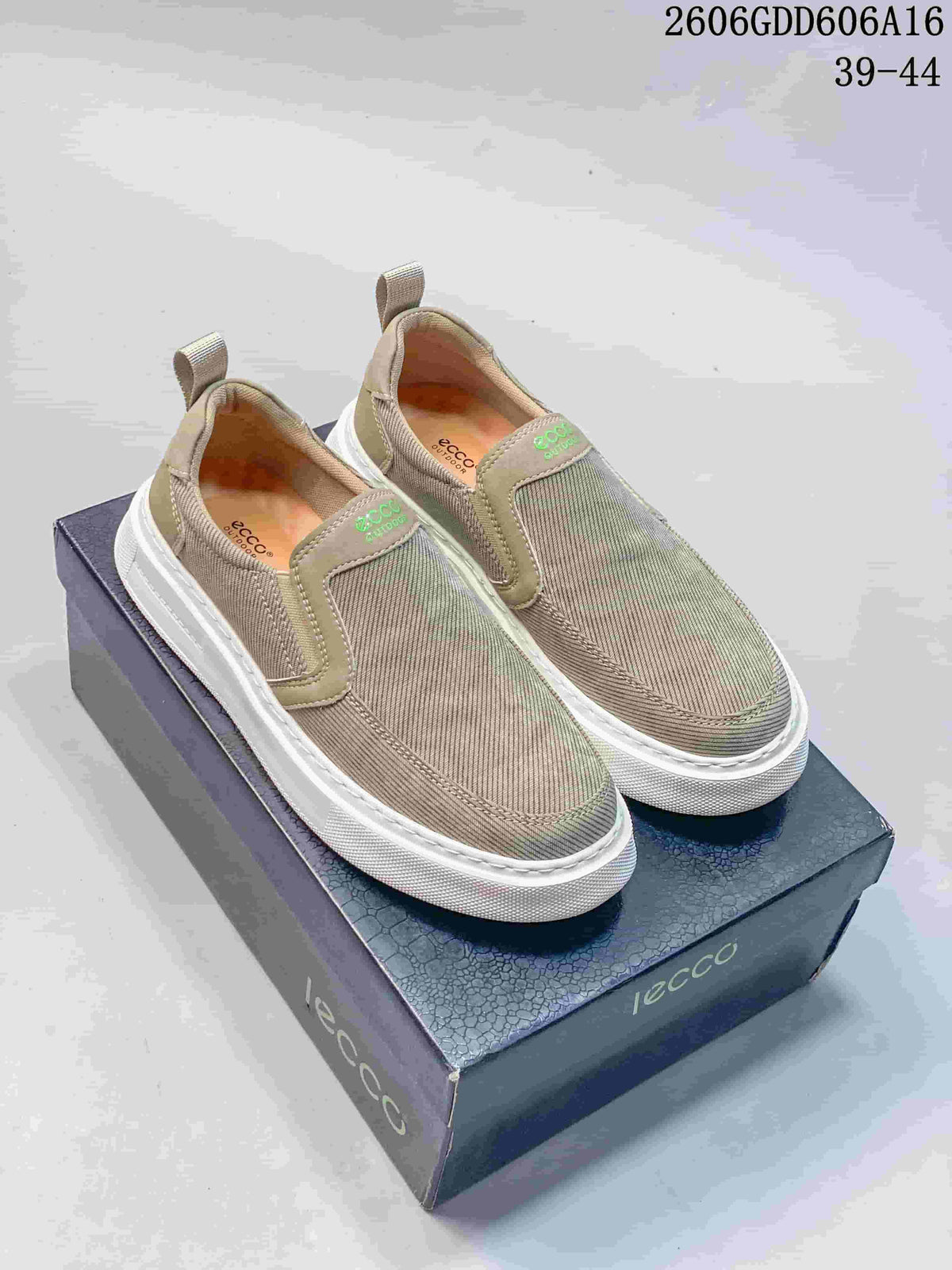 Pair of taupe and gray ECCO slip-on sneakers with white soles, shown on a shoebox