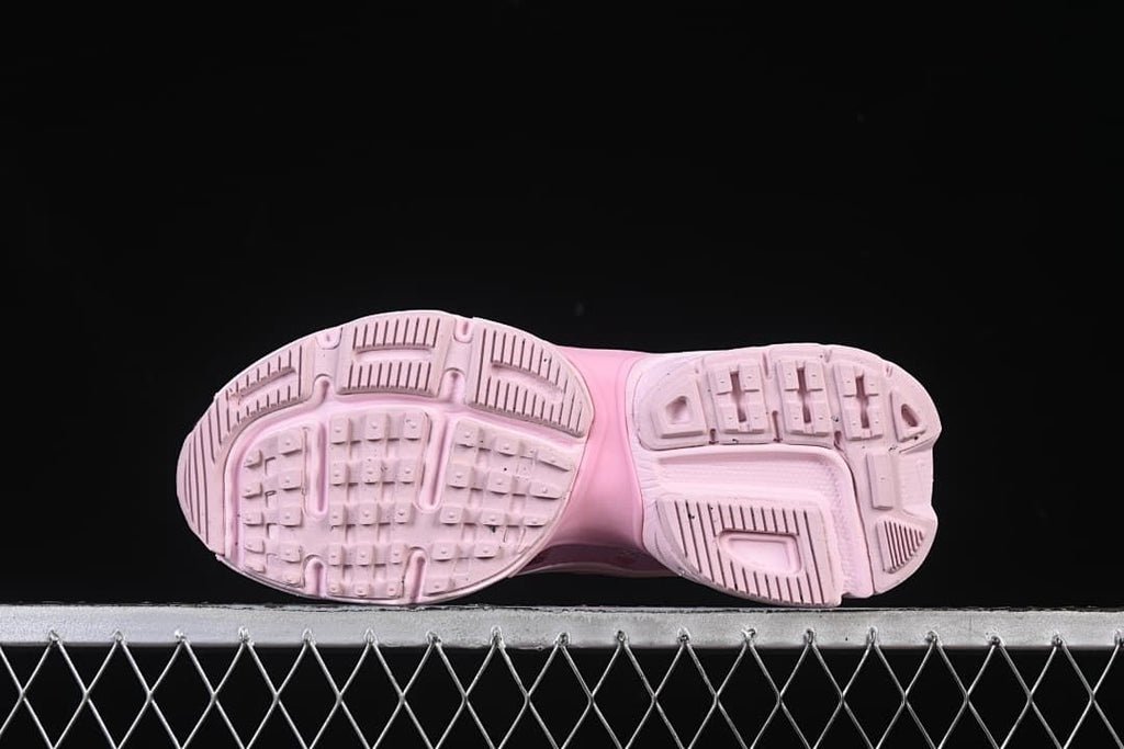 Underside view showing the patterned tread on the pink outsole.