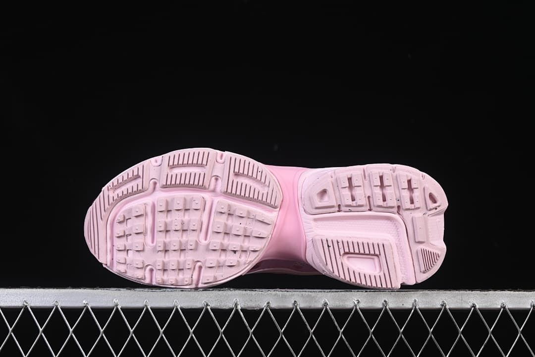 Underside view showing the patterned tread on the pink outsole.
