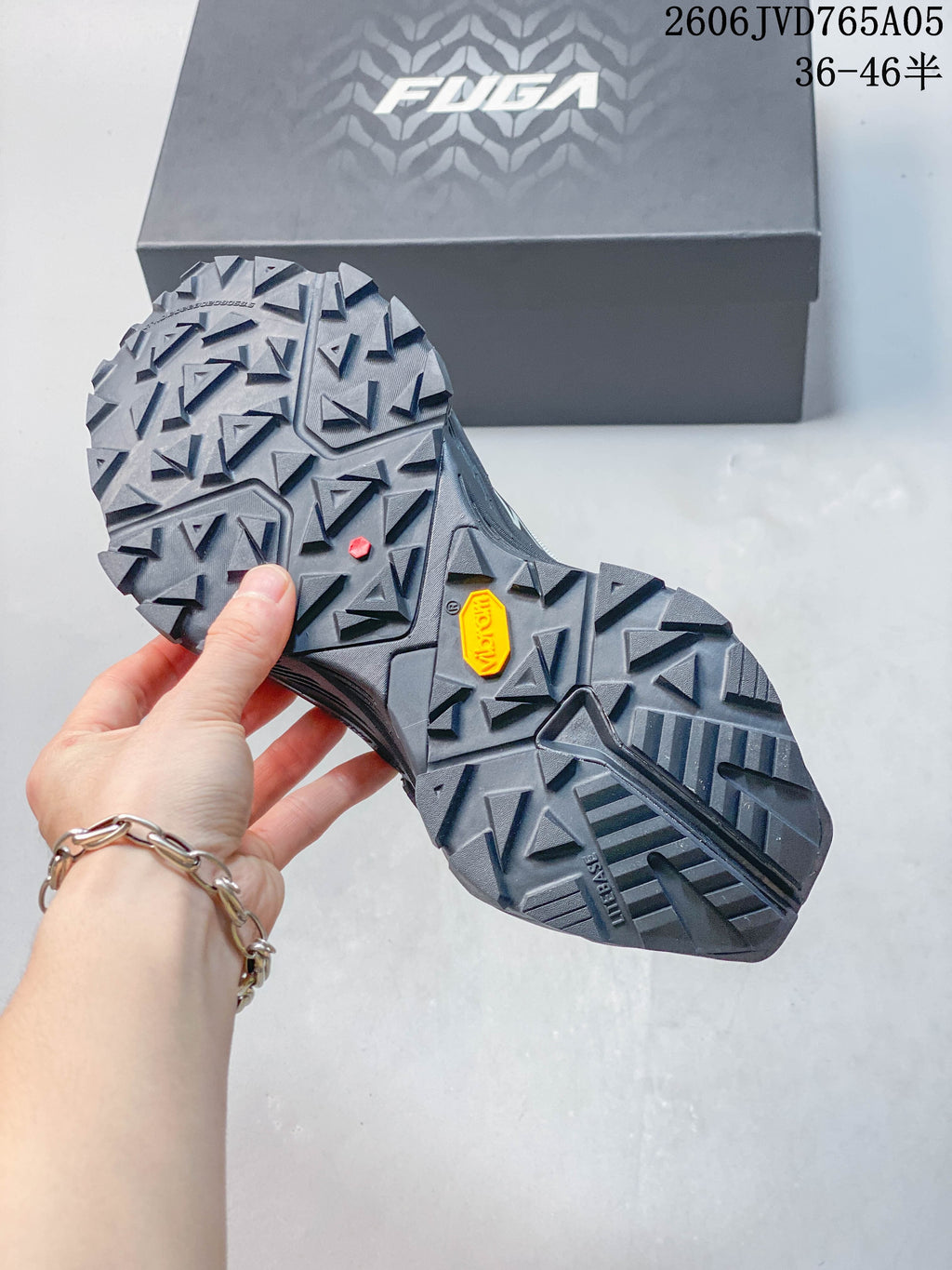 Close-up of the trail shoe outsole showing deep angular lugs and Vibram branding.