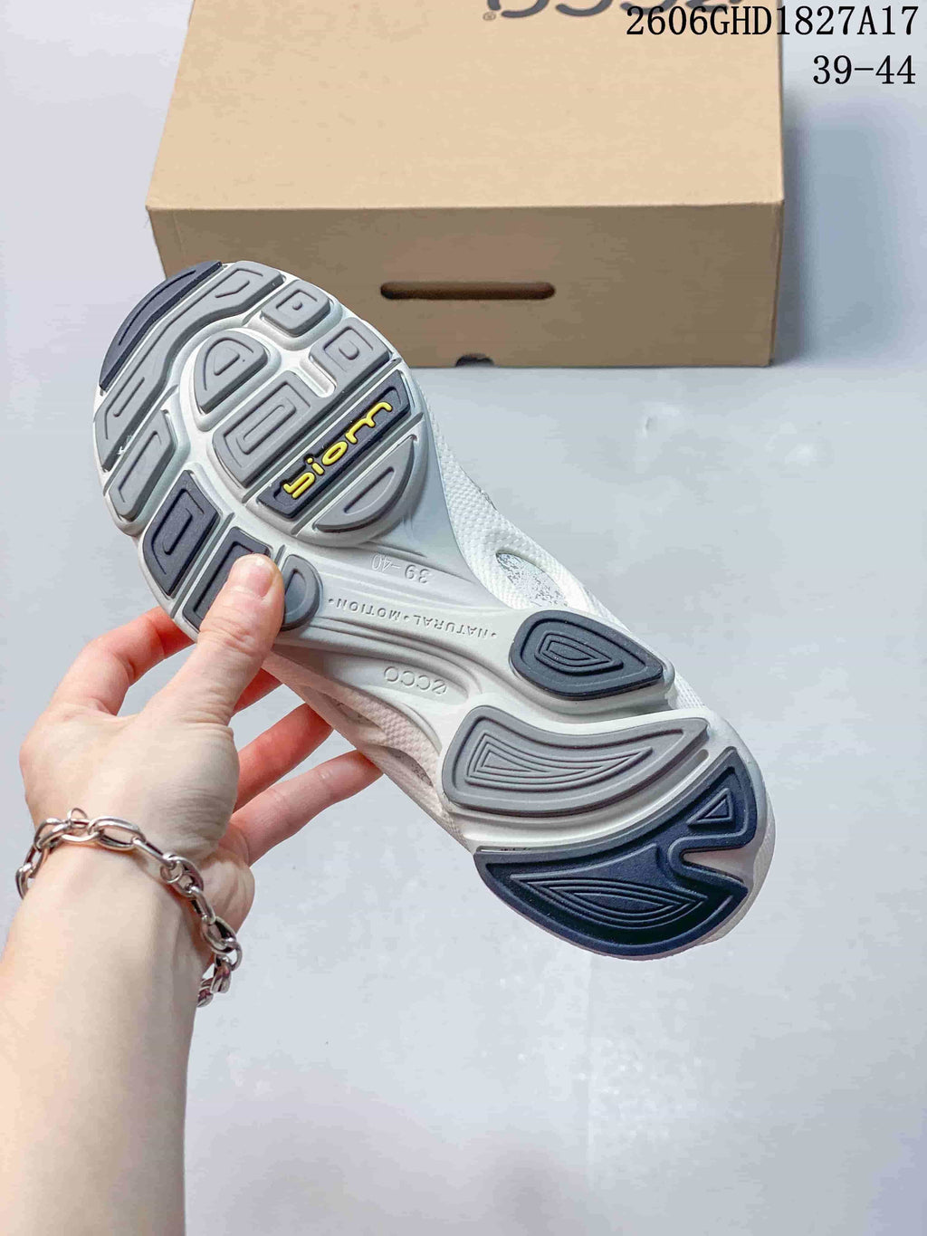 Underside of an ECCO sneaker showing a sculpted gray outsole and BIOM lettering.