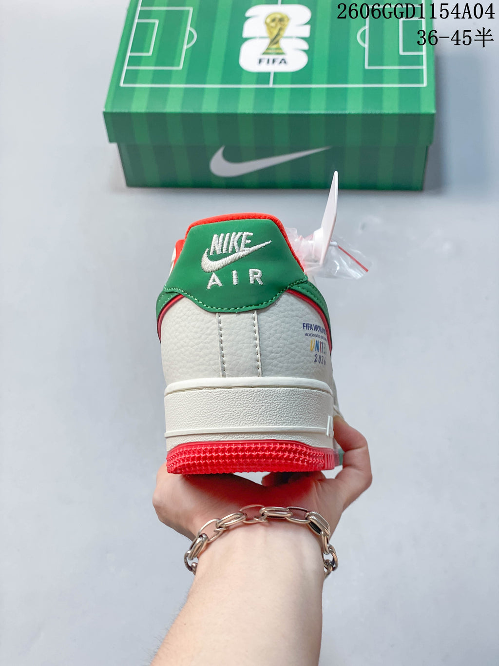 Rear view showing the green heel panel and red outsole accent