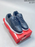 Dark gray Nike Ebernon Low sneakers shown from above on a red shoebox