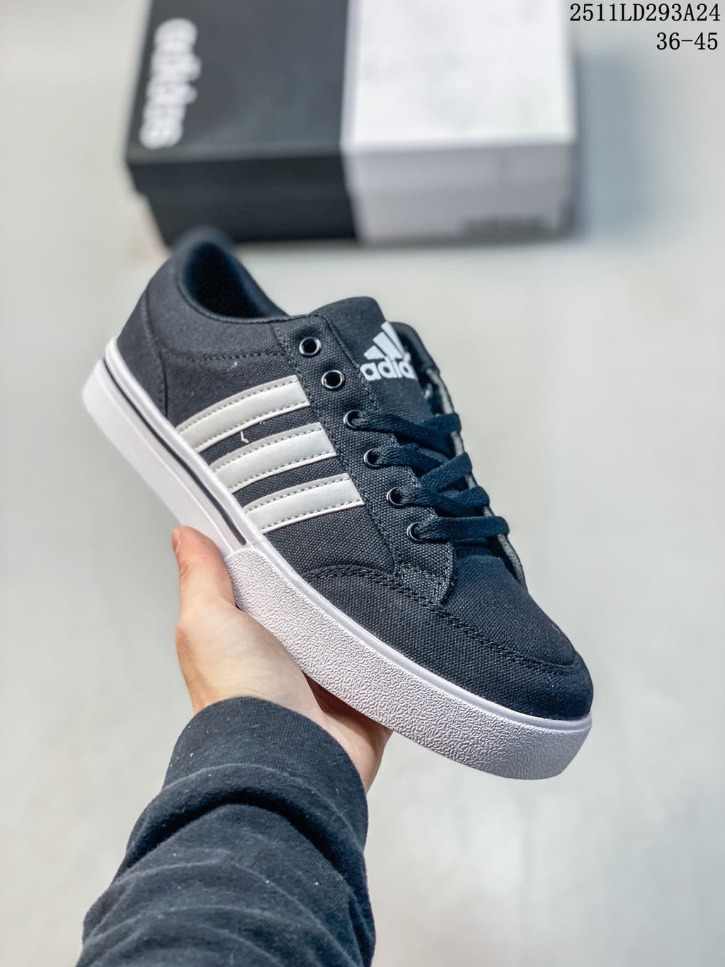 Angled side view of the navy sneaker with white stripes and a white sole.