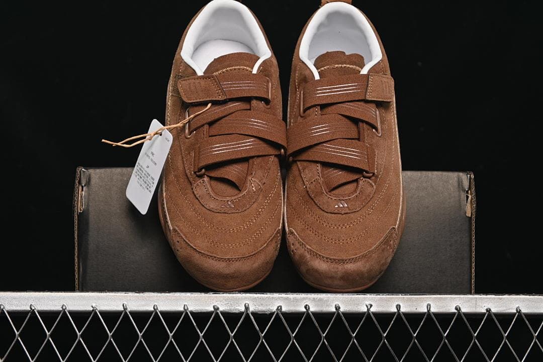 Pair of brown strap sneakers viewed from the front