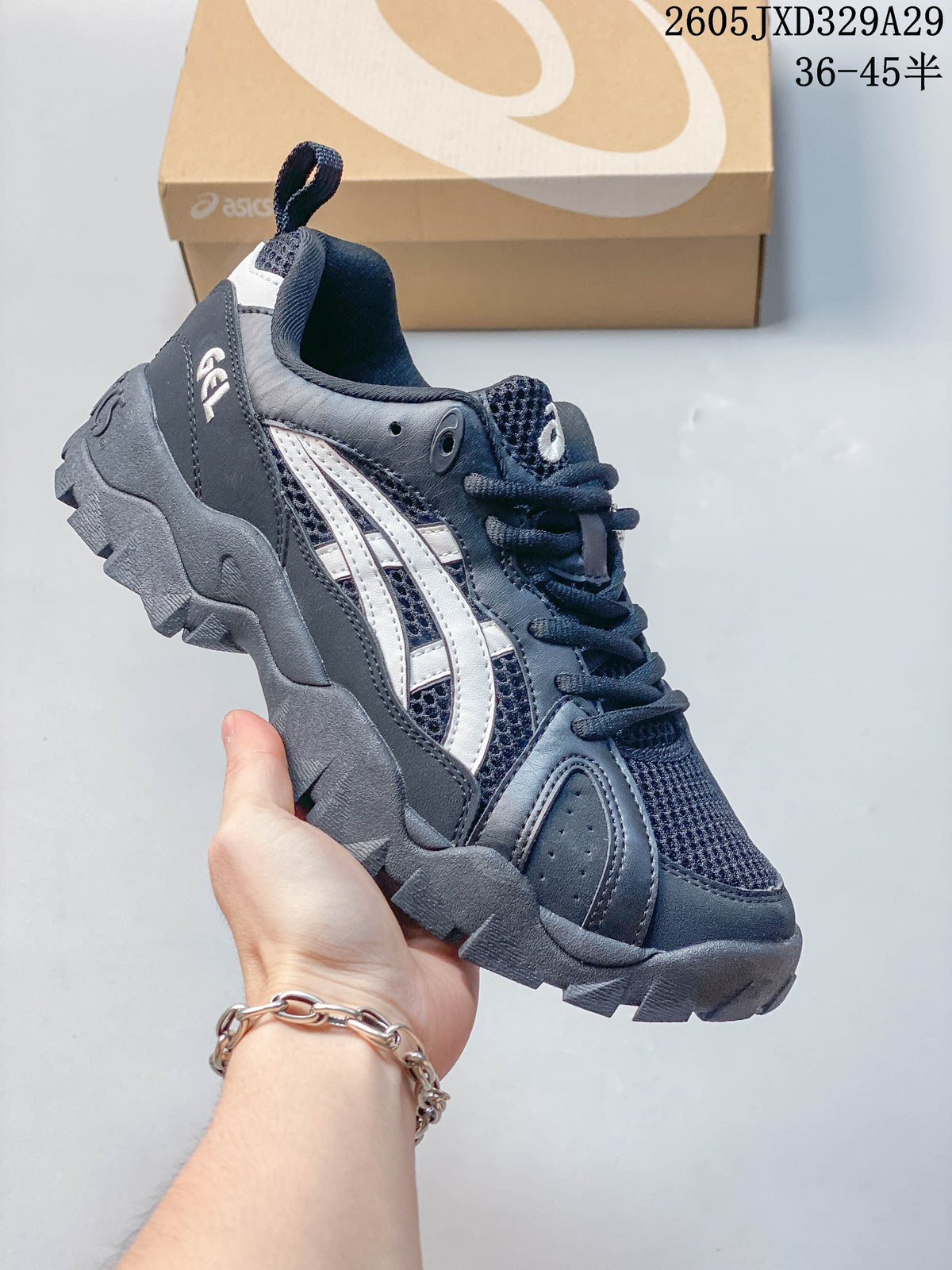 Side view of a dark navy Onitsuka Tiger sneaker with light stripes and a deep-tread outsole.