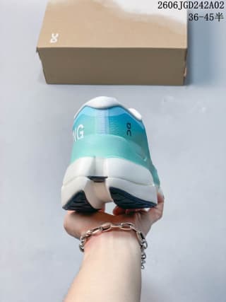Rear view showing the turquoise heel section, white cushioning area and dark outsole details.