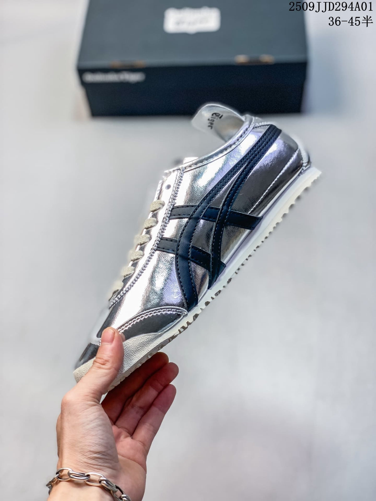 Side profile of a silver sneaker with dark stripes and a light-colored sole.
