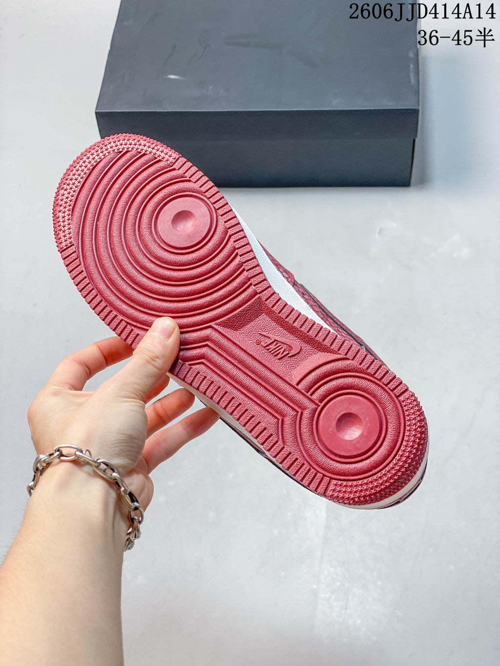 Close-up of the red outsole with circular tread details