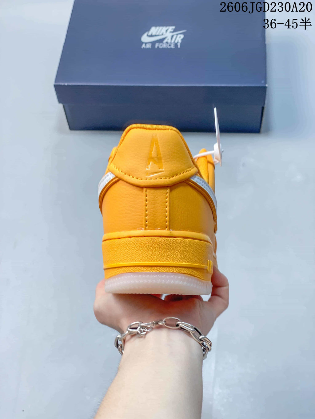 Rear view of a yellow Nike Air Force 1 sneaker with a white outsole