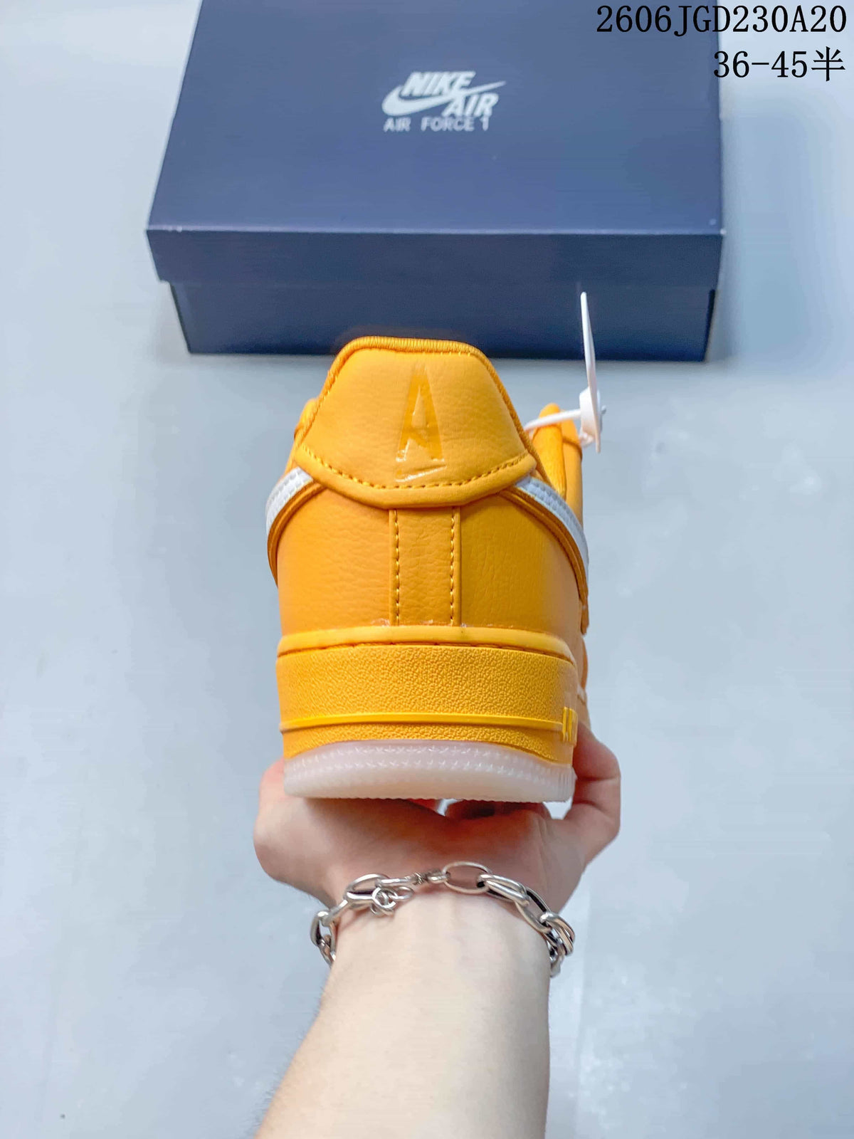 Rear view of a yellow Nike Air Force 1 sneaker with a white outsole
