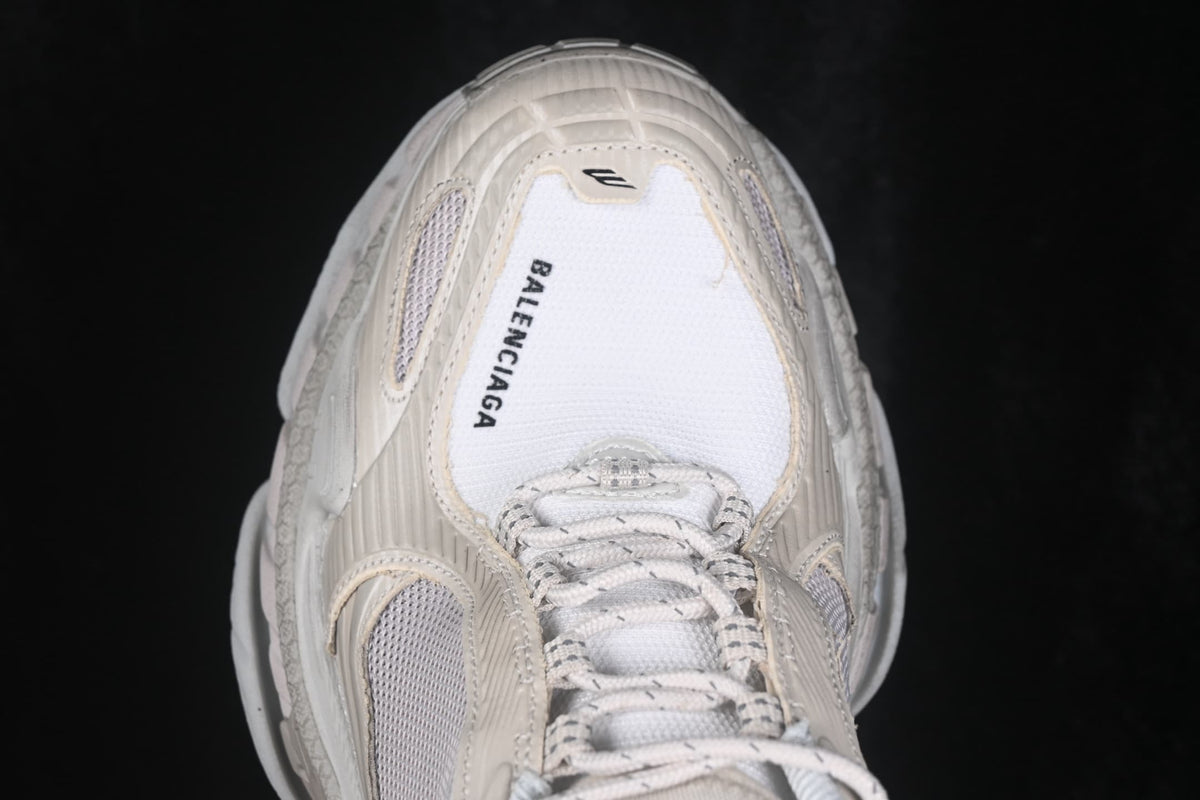 Top view of the cream sneaker showing the mesh tongue, laces and Balenciaga text on the toe area.