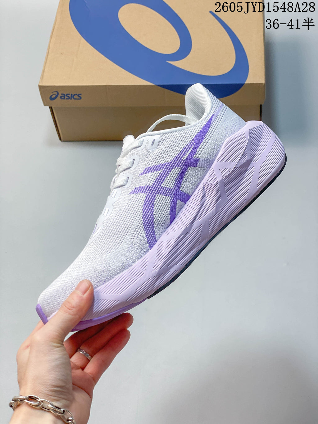 Side profile of a white and purple ASICS NOVABLAST 6 running shoe