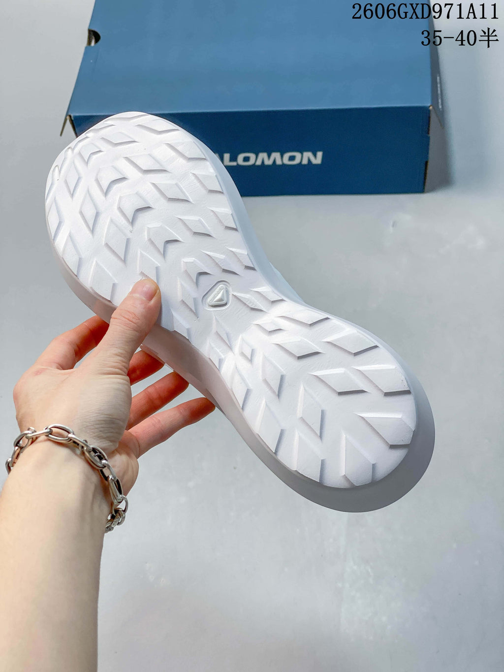Close-up of the white sneaker outsole with a geometric tread pattern