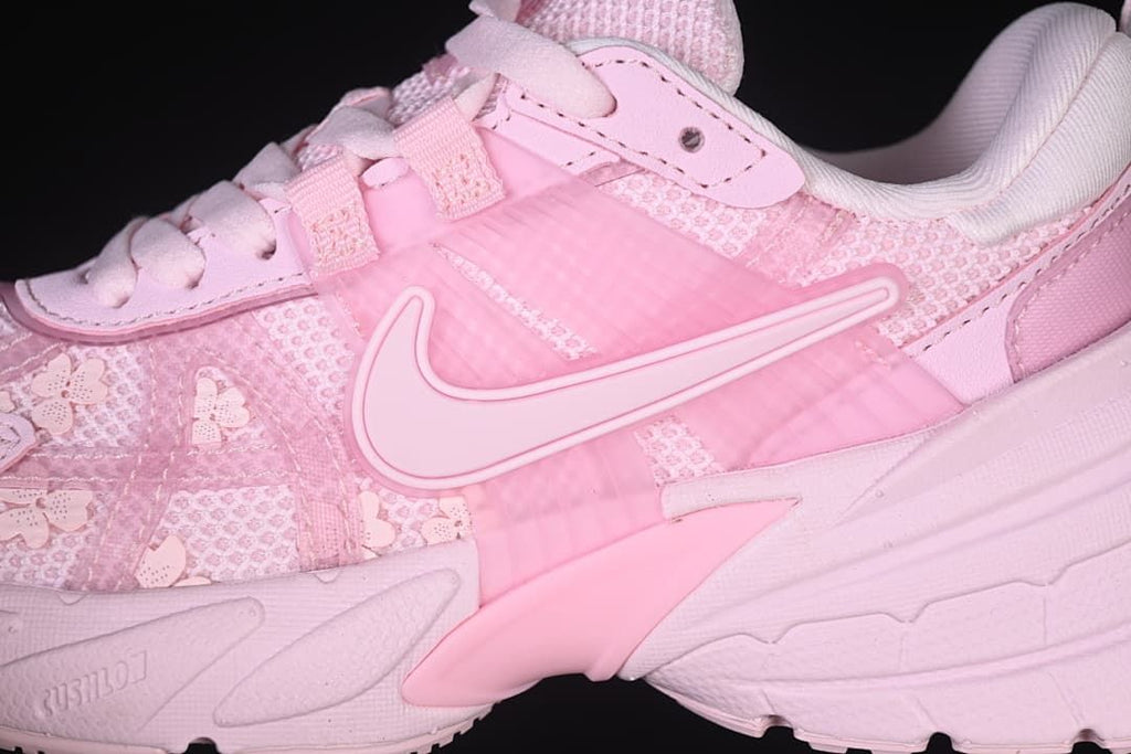 Close-up of the pink side panels, swoosh, and sculpted midsole